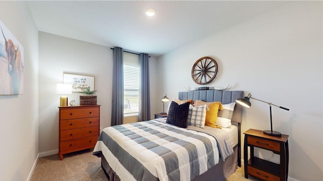 bedroom with light carpet and baseboards