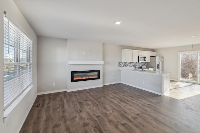 unfurnished living room featuring dark hardwood / wood-style flooring