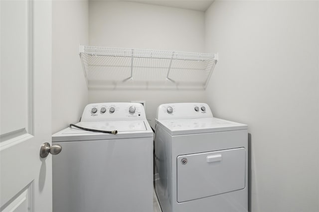 washroom with separate washer and dryer