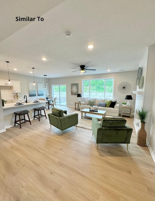 625 W Wright Rd, Norwalk, IA 50211 - living room featuring light wood-style floors, recessed lighting, healthy amount of natural light, baseboards, and a ceiling fan