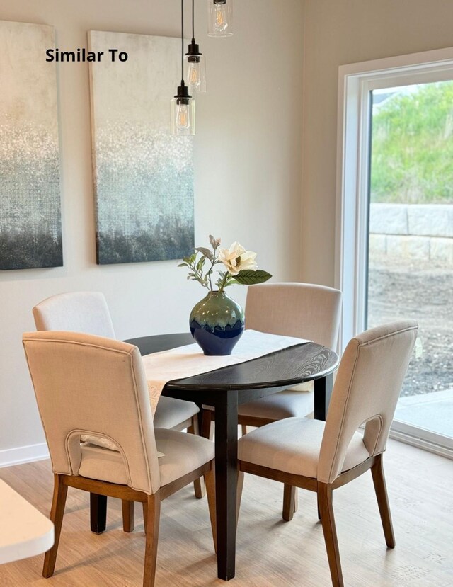 625 W Wright Rd, Norwalk, IA 50211 - dining area featuring light wood-style flooring and baseboards