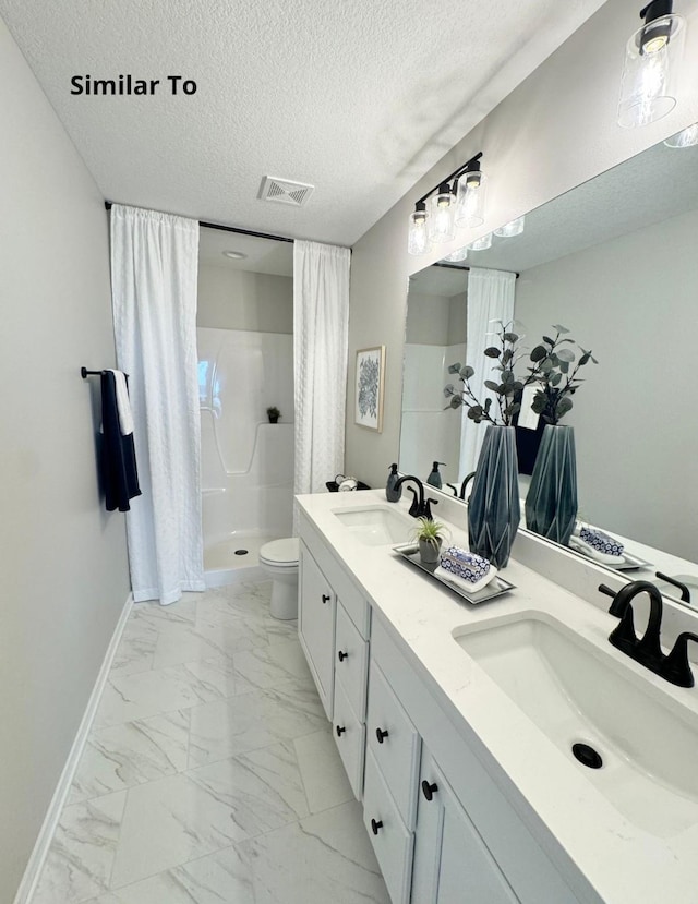 625 W Wright Rd, Norwalk, IA 50211 - full bathroom with a shower stall, double vanity, marble look tile flooring, a textured ceiling, and toilet