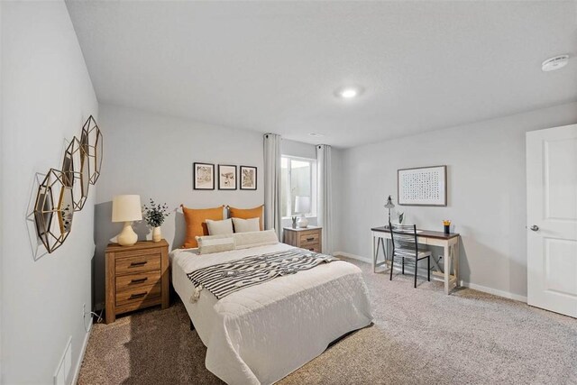 carpeted bedroom featuring visible vents and baseboards