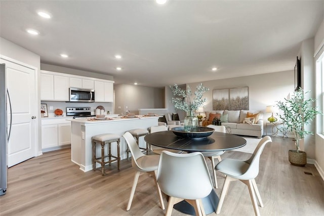 dining area with visible vents, recessed lighting, and light wood-type flooring