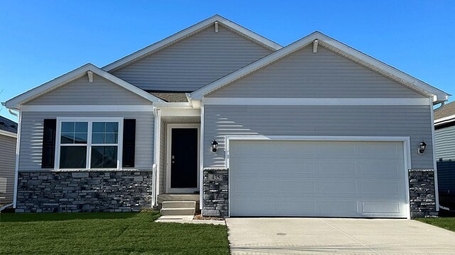 craftsman house with a garage and a front lawn