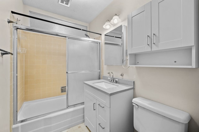 full bathroom with vanity, toilet, enclosed tub / shower combo, and a textured ceiling