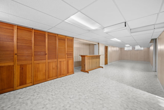 basement with carpet and a paneled ceiling