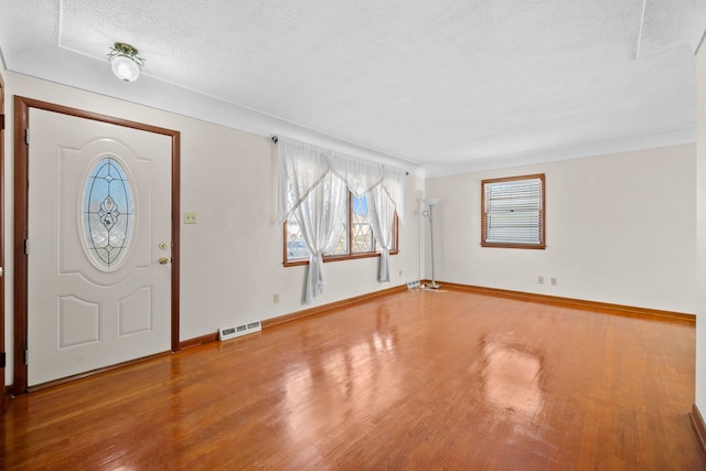 entryway featuring hardwood / wood-style floors and a textured ceiling