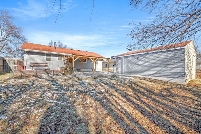 rear view of property with a jacuzzi and a patio area