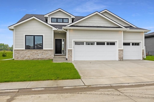 craftsman-style house featuring a front yard and a garage