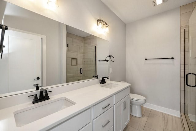 bathroom featuring tile patterned floors, vanity, an enclosed shower, and toilet