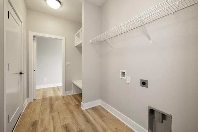 laundry area with hookup for a washing machine, light hardwood / wood-style flooring, and hookup for an electric dryer