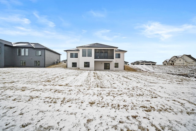 view of snow covered rear of property