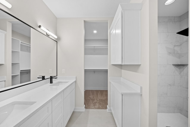 bathroom featuring vanity and tiled shower