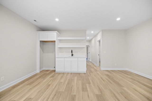 unfurnished living room featuring light wood-type flooring, baseboards, and recessed lighting