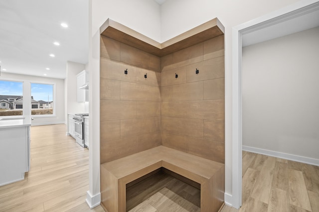 mudroom featuring recessed lighting, light wood-style flooring, and baseboards