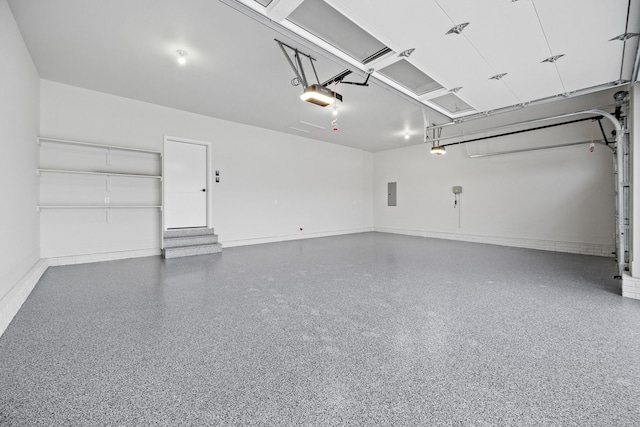 garage featuring a garage door opener, electric panel, and baseboards