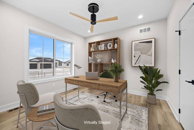 office with ceiling fan, light wood finished floors, visible vents, and baseboards