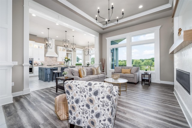 living room with dark hardwood / wood-style flooring, a tile fireplace, crown molding, and plenty of natural light