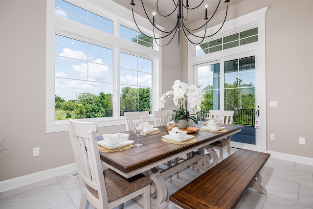 dining space featuring a chandelier and light tile patterned floors