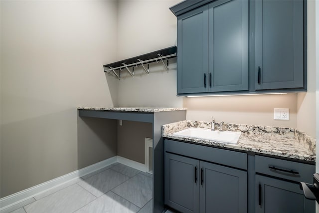 laundry area with sink and light tile patterned floors