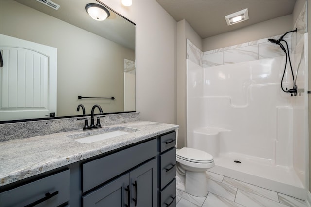 bathroom with toilet, vanity, and walk in shower