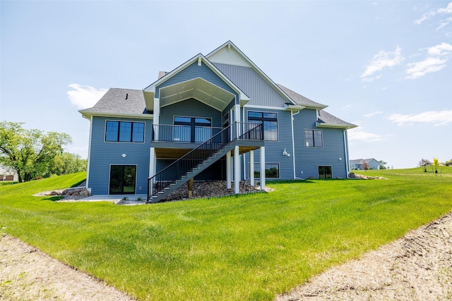 rear view of property with a lawn and a deck