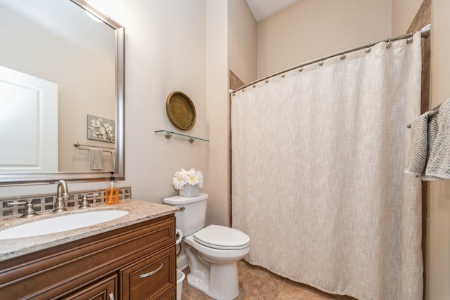 bathroom with toilet, tile patterned floors, and vanity