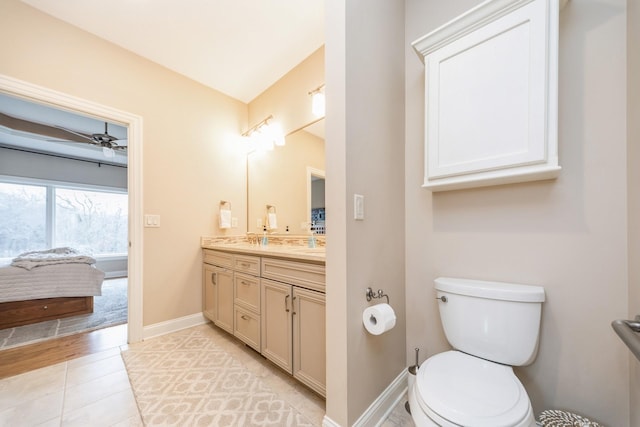 bathroom with ceiling fan, vanity, tile patterned floors, and toilet