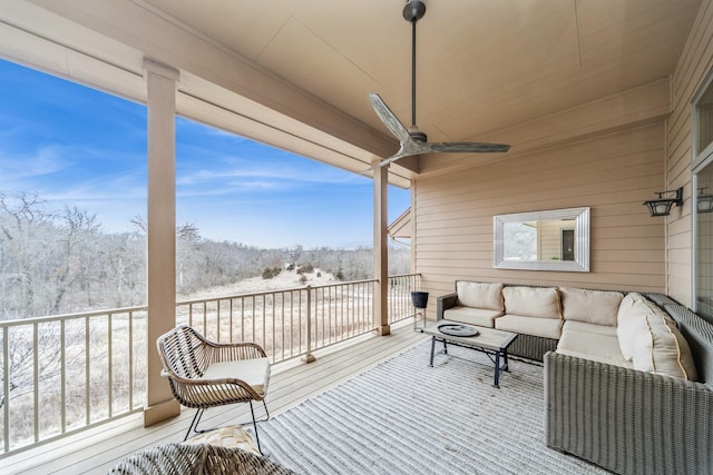 wooden deck with ceiling fan and an outdoor living space