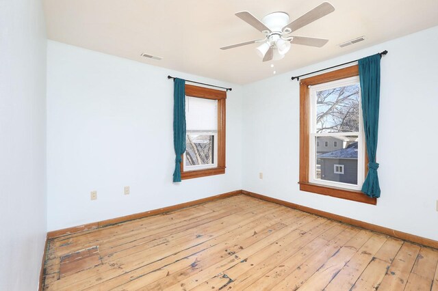 empty room featuring ceiling fan and hardwood / wood-style flooring