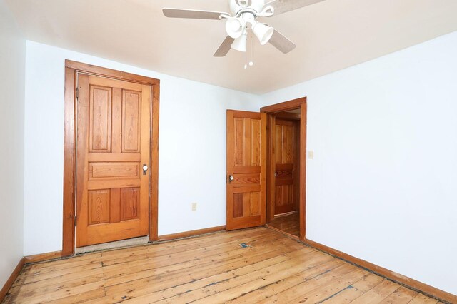 unfurnished bedroom featuring ceiling fan and light hardwood / wood-style floors