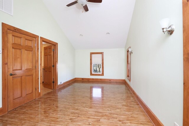 unfurnished room with lofted ceiling, ceiling fan, and light hardwood / wood-style flooring