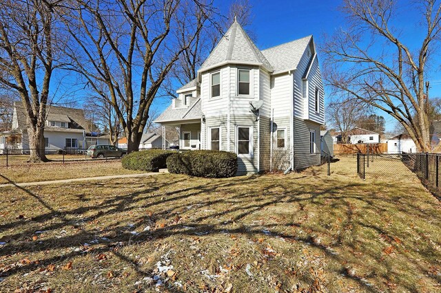 view of side of home featuring a lawn