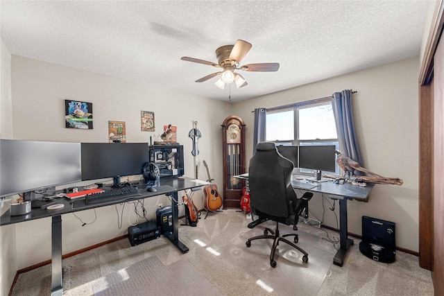 home office featuring a textured ceiling, ceiling fan, and carpet