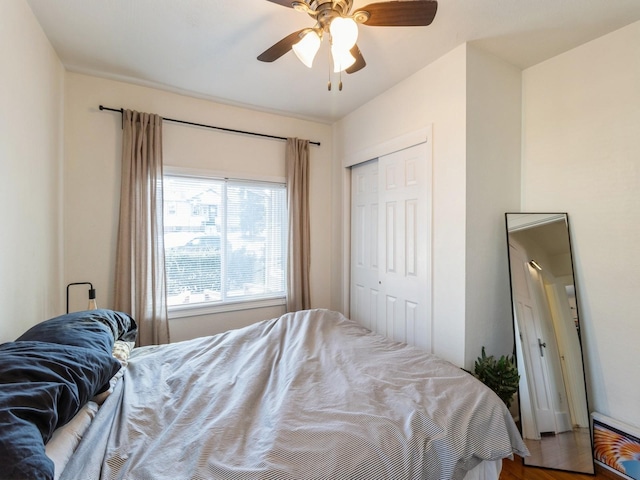 bedroom featuring hardwood / wood-style floors, a closet, and ceiling fan