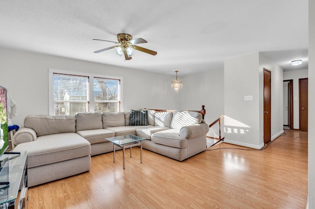 living room with ceiling fan and light hardwood / wood-style flooring