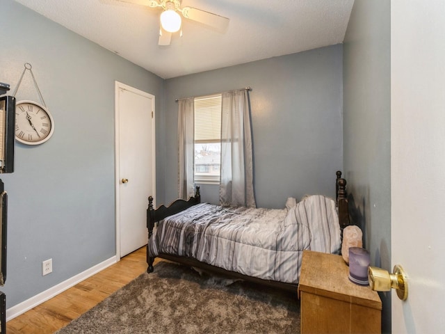 bedroom with ceiling fan and hardwood / wood-style floors