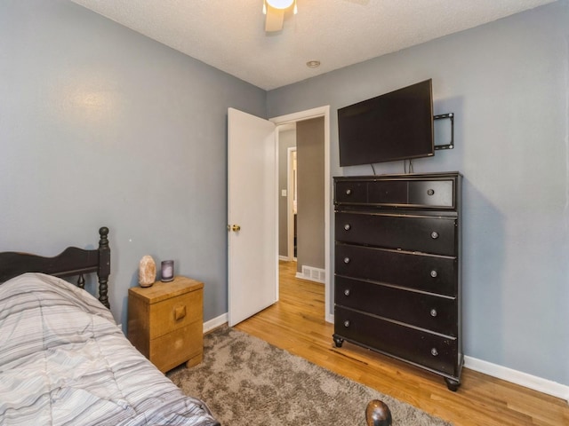 bedroom with light wood-type flooring and ceiling fan