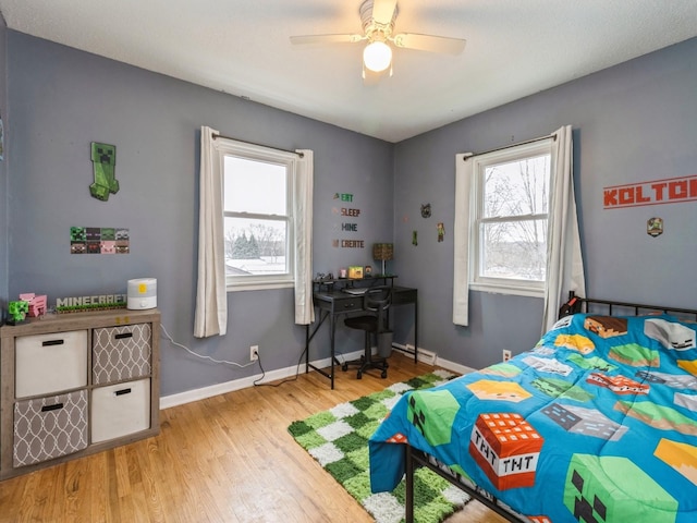 bedroom with ceiling fan and light hardwood / wood-style floors