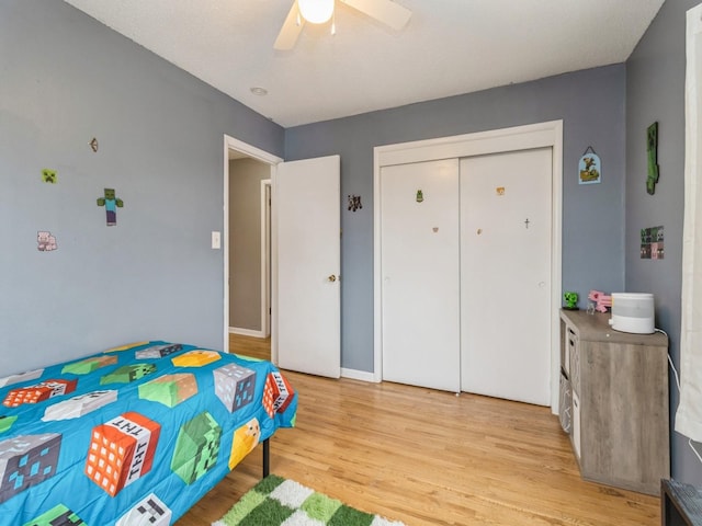 bedroom with a closet, ceiling fan, and light wood-type flooring