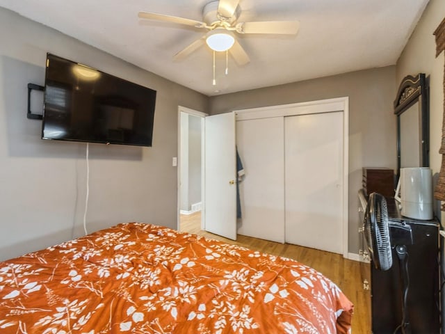 bedroom featuring a closet, ceiling fan, and light hardwood / wood-style flooring