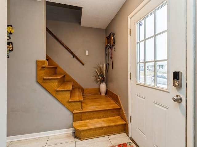 doorway with light tile patterned floors