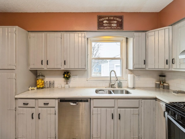 kitchen with white cabinets, range with gas stovetop, sink, stainless steel dishwasher, and backsplash