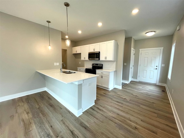 kitchen featuring sink, dark wood-type flooring, white cabinets, black / electric stove, and decorative light fixtures