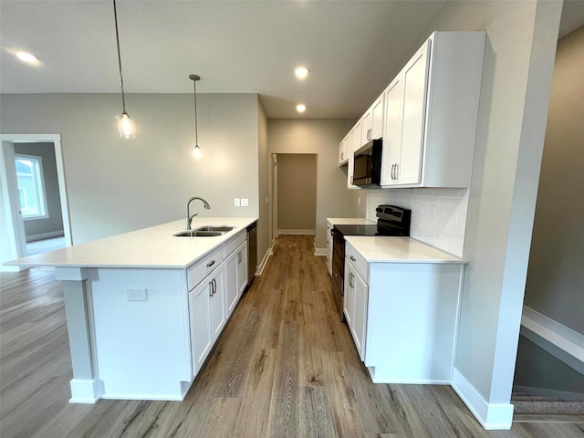 kitchen with sink, tasteful backsplash, decorative light fixtures, stainless steel appliances, and white cabinets