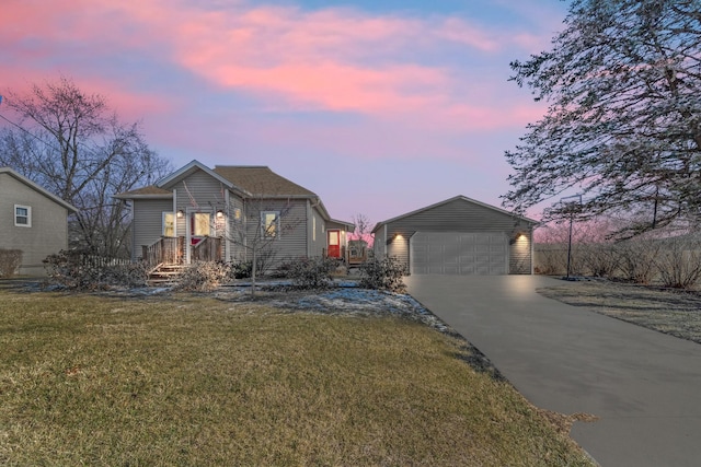 view of front of property with a yard and a garage