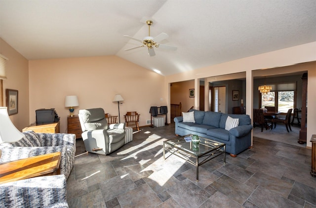 living room featuring lofted ceiling and ceiling fan with notable chandelier