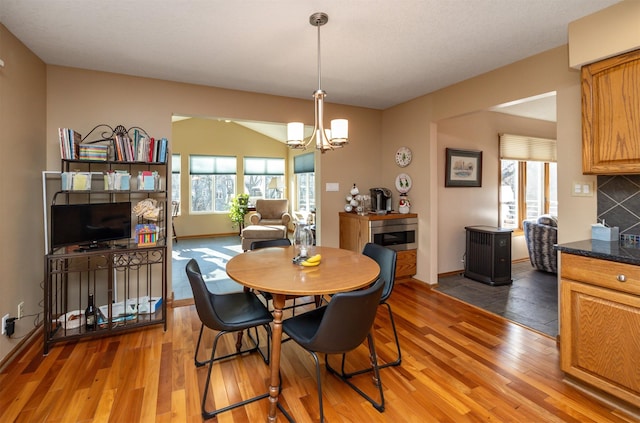 dining area with a notable chandelier and wood-type flooring