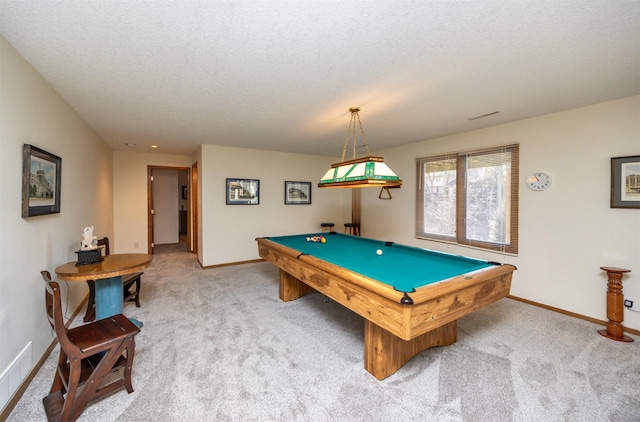 recreation room featuring pool table, a textured ceiling, and light colored carpet